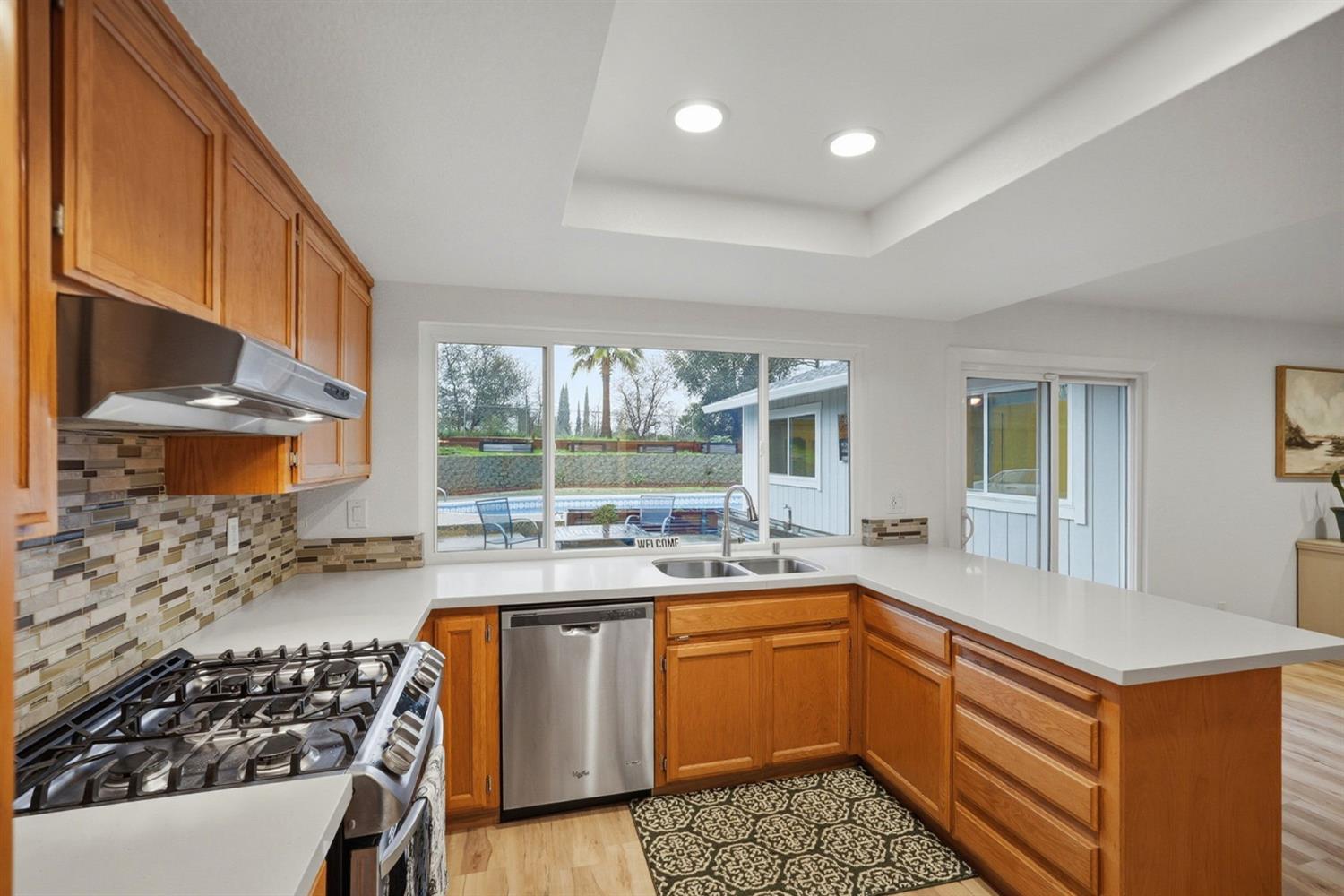 5932 Angelo Drive Loomis, CA 95650 - Photo 16 of 32 a kitchen with a sink stove and cabinets