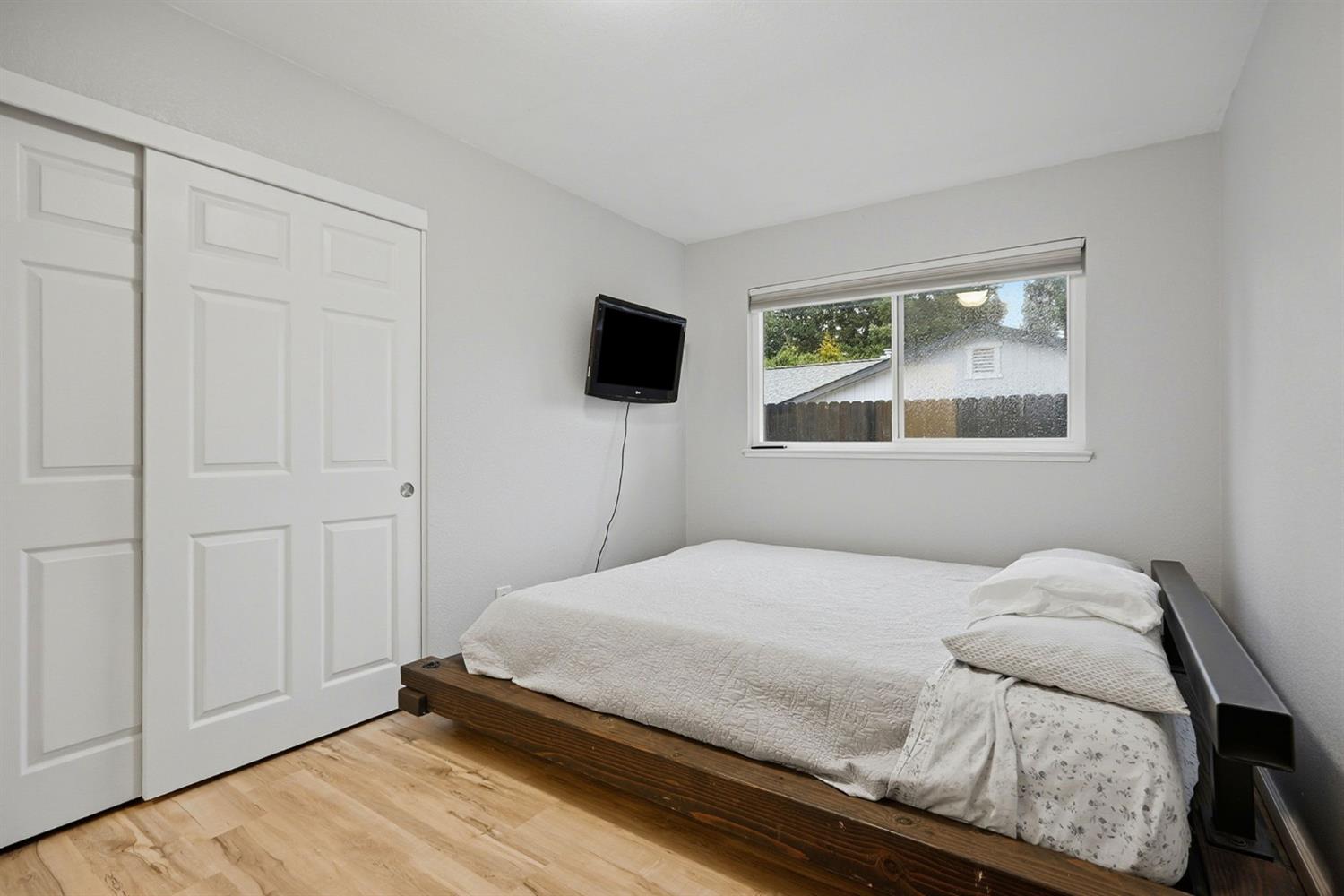 5932 Angelo Drive Loomis, CA 95650 - Photo 22 of 32 a bedroom with a bed and a flat tv screen