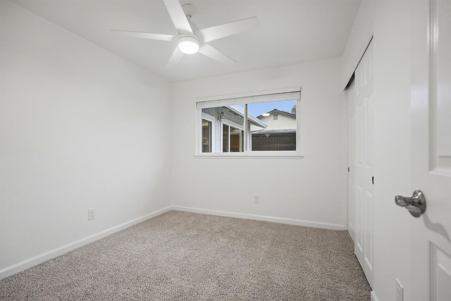 5932 Angelo Drive Loomis, CA 95650 - Photo 23 of 32 an empty room with a ceiling fan and a window