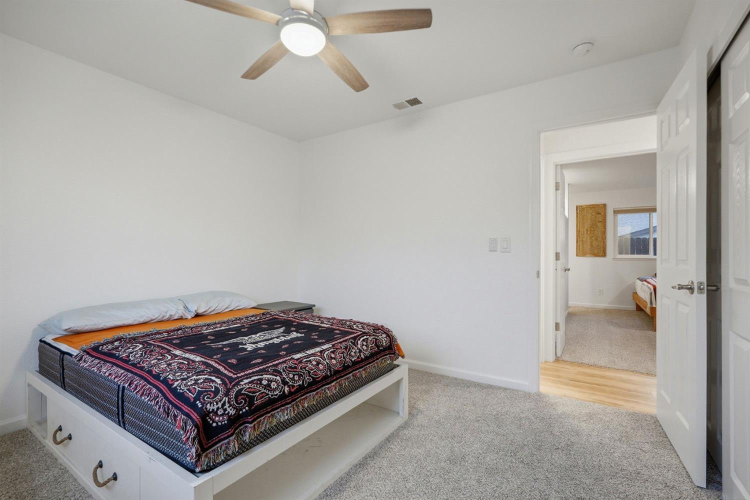 5932 Angelo Drive Loomis, CA 95650 - Photo 26 of 32 a bedroom with a bed and glass door