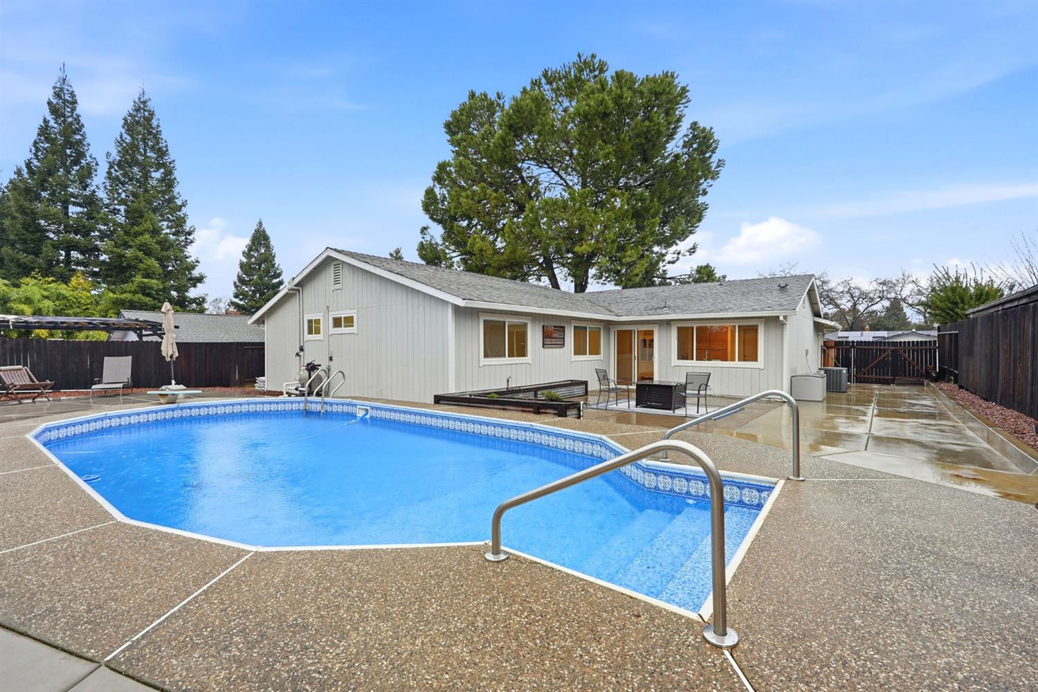 5932 Angelo Drive Loomis, CA 95650 - Photo 32 of 32 a view of house with swimming pool outdoor seating and house in the background