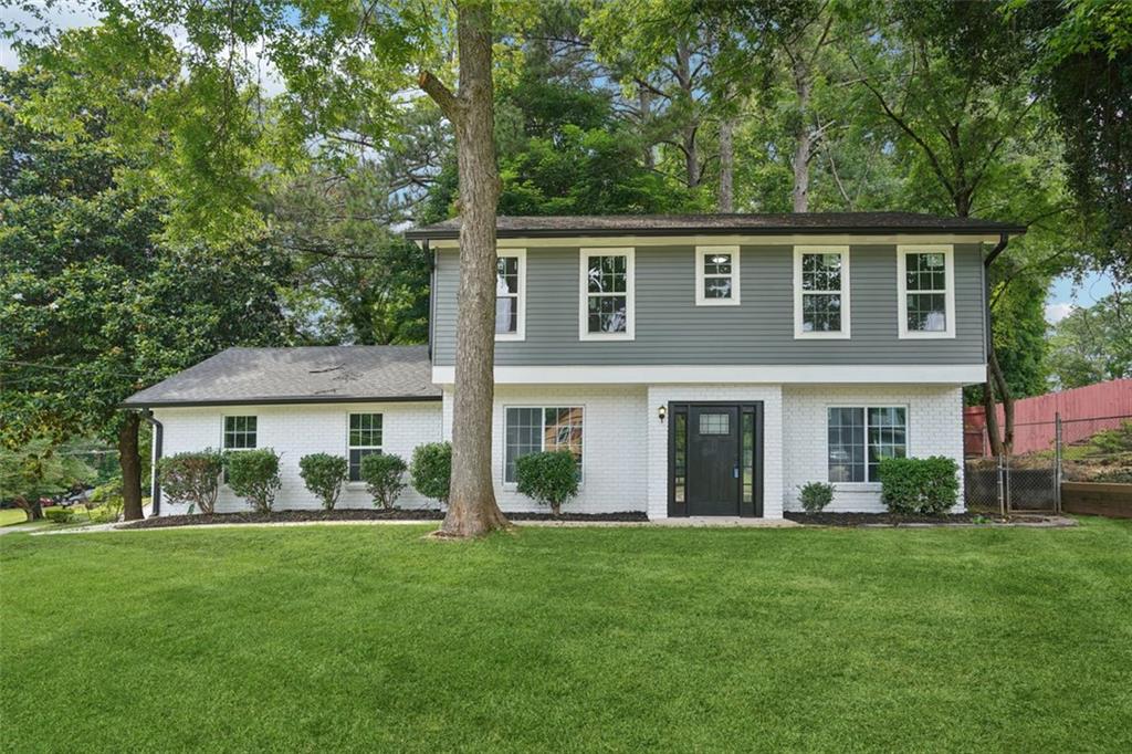 2079 Wellborn Road Lithonia, GA 30058 - Photo 1 of 1 a front view of a house with a garden