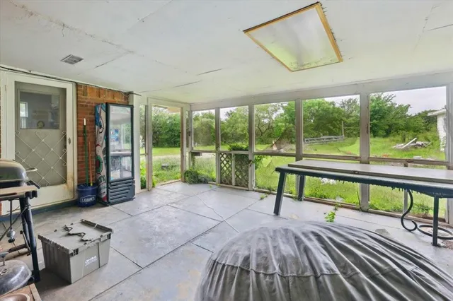 a view of a chairs and table in patio of a house