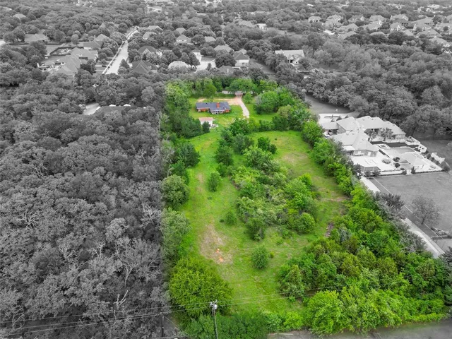 an aerial view of a houses with a yard