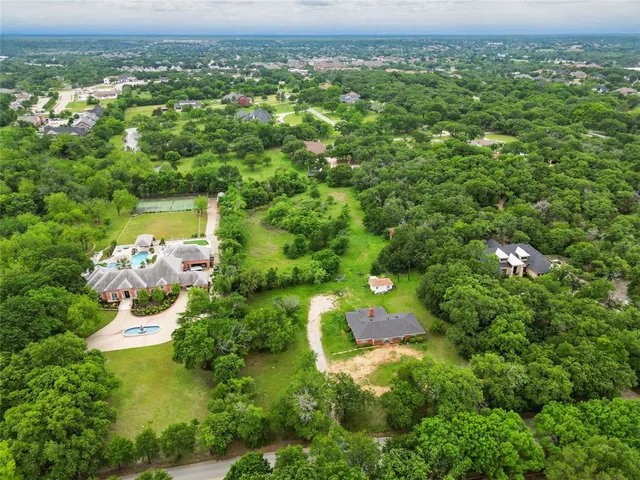a view of a green field with lots of bushes