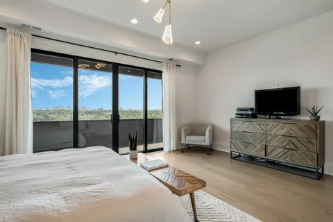 a bedroom with furniture and flat screen tv