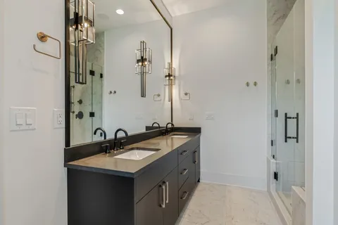 a bathroom with a sink double vanity and a mirror