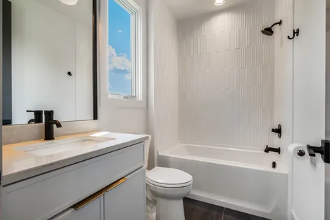 a bathroom with a sink a toilet and a bathtub