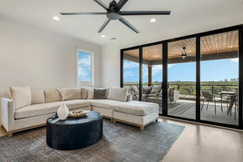 a living room with furniture and large windows