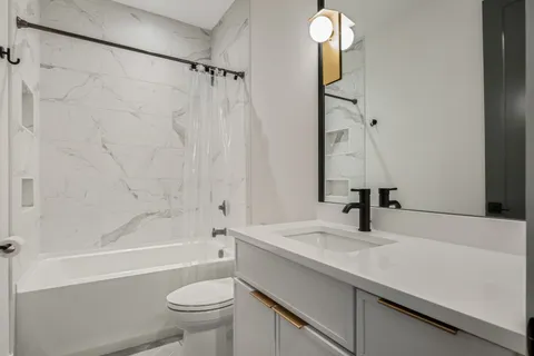 a bathroom with a sink a toilet and a bathtub