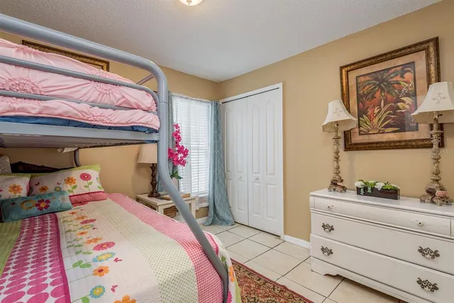 a bed room with a bed and potted plants