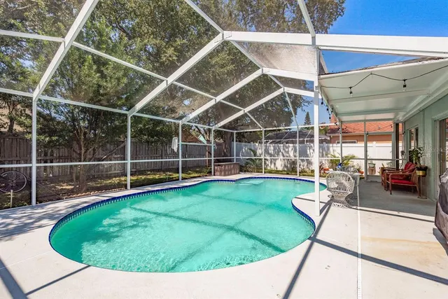 a view of a swimming pool with an outdoor seating