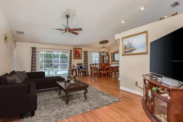 a living room with furniture a rug and a flat screen tv