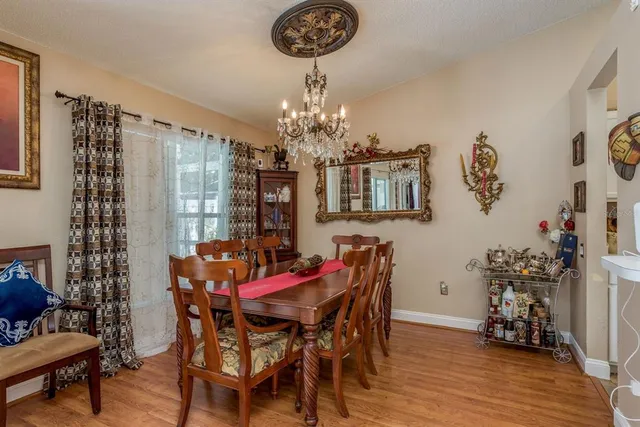 a view of a dining room with furniture and chandelier