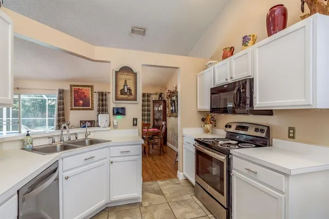 a kitchen with stainless steel appliances granite countertop a sink and a stove