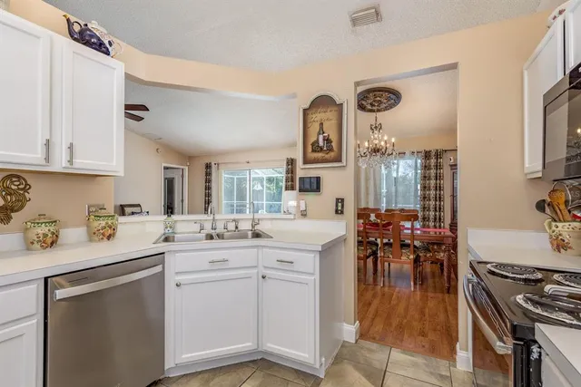 a kitchen with a sink stove and cabinets