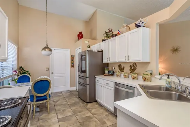 a kitchen with a sink cabinets and appliances