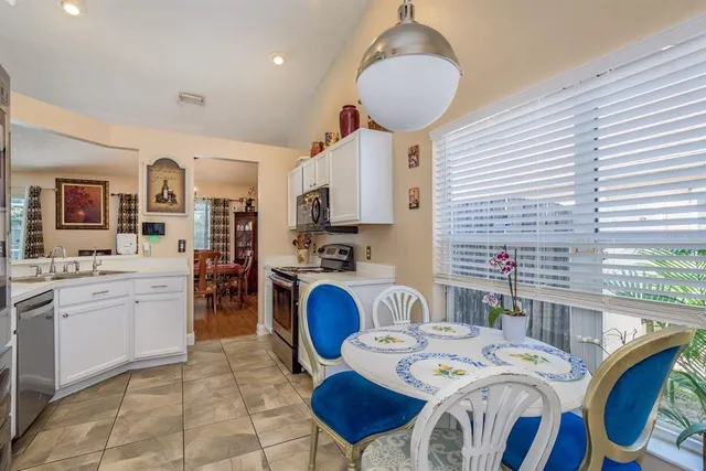 a very nice looking open dining room with kitchen island furniture