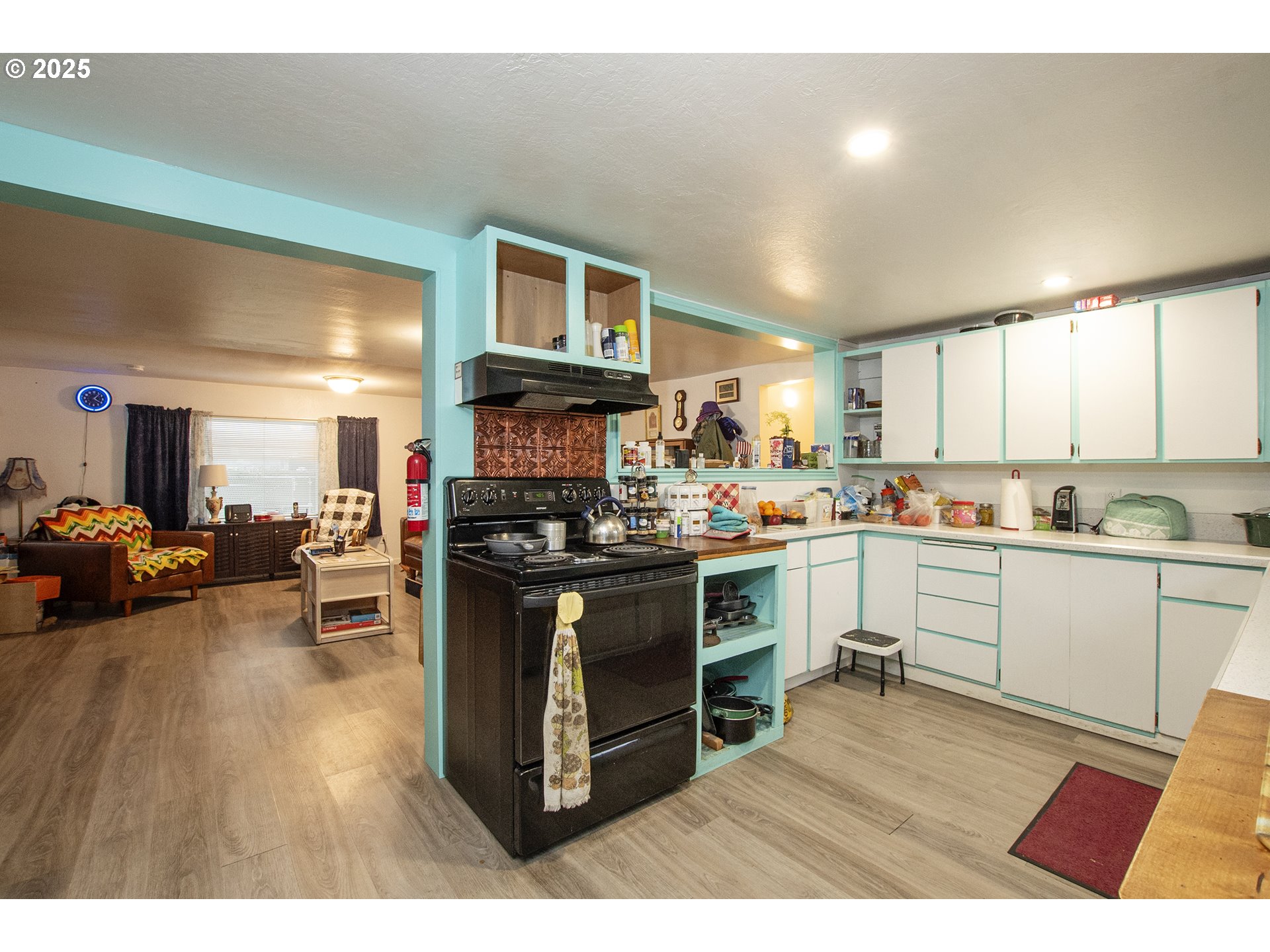 1253 30th Street Springfield, OR 97478 - Photo 5 of 15 a kitchen with stainless steel appliances kitchen island granite countertop a stove top oven a sink a dining table and chairs