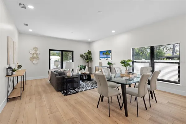 a view of a dining room with furniture and wooden floor