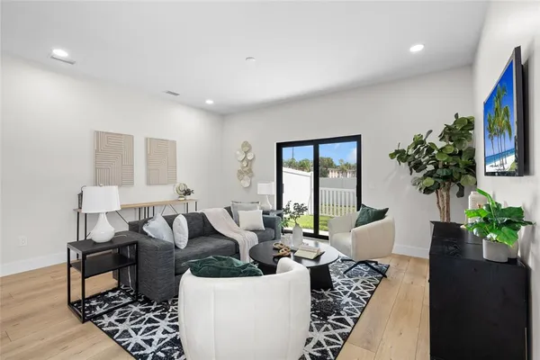 a living room with furniture and a potted plant