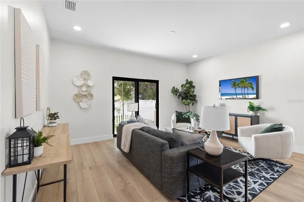 a living room with furniture and wooden floor