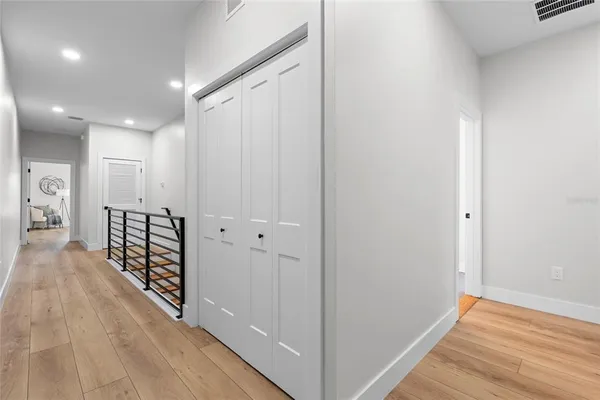 a view of a hallway with wooden floor