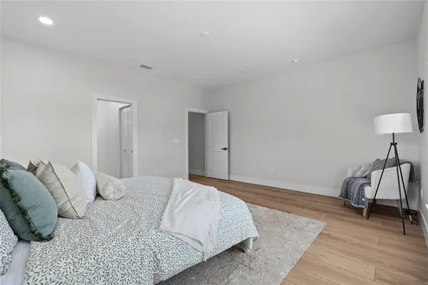 a bedroom with a bed and a lamp on table