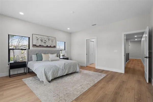 a bedroom with a bed and a painting on the wall