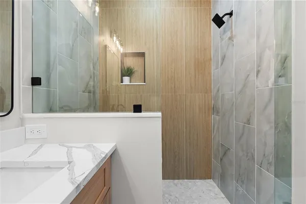 a bathroom with a tub a sink and a shower