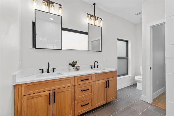 a bathroom with a toilet sink and mirror