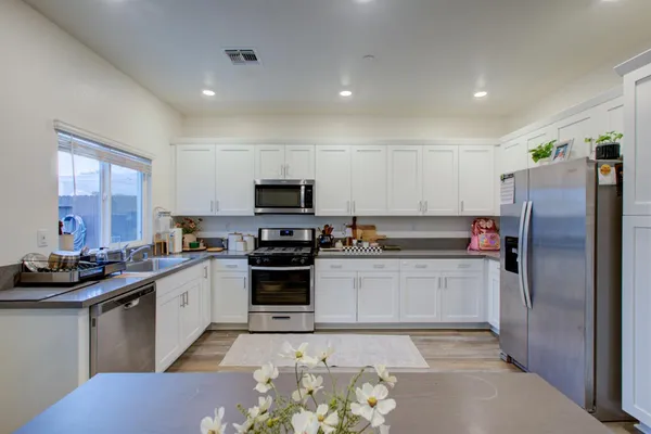 a bathroom with a sink a toilet a mirror and shower