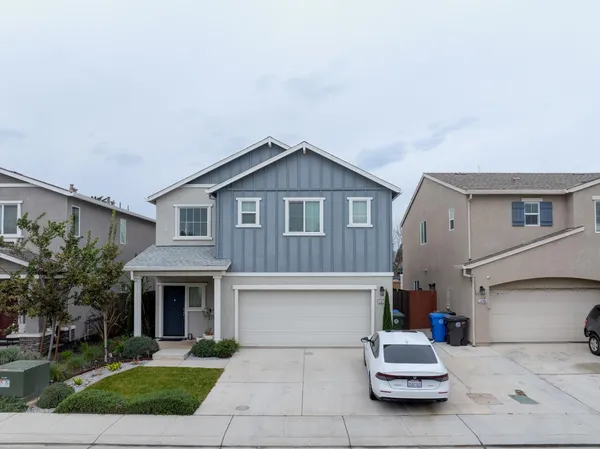 a bedroom with a bed and a potted plant