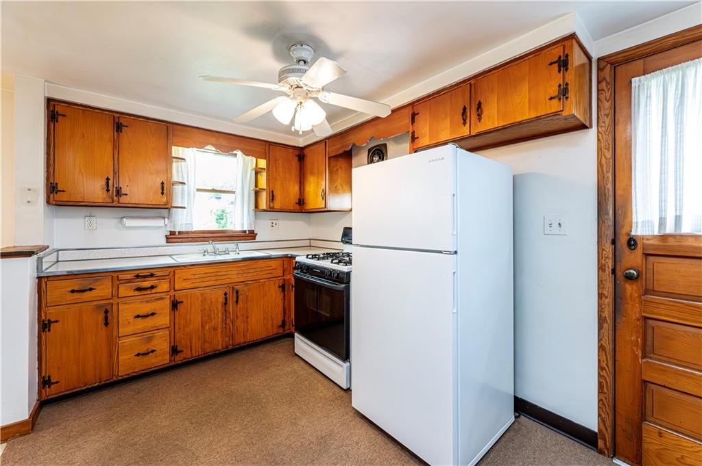 13740 Ridge Road Irwin, PA 15642 - Photo 12 of 43 a kitchen with stainless steel appliances granite countertop a refrigerator a sink dishwasher a stove and a microwave oven