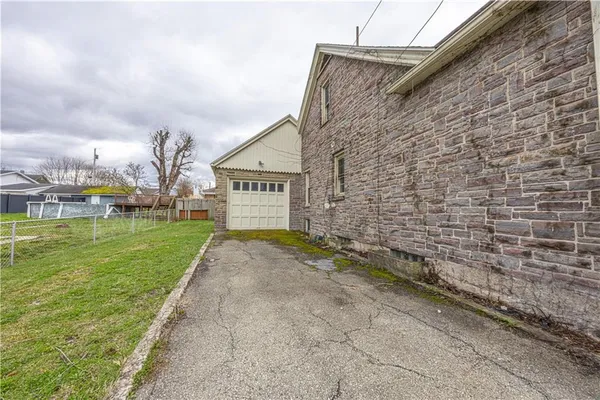 a pathway of a house with a yard