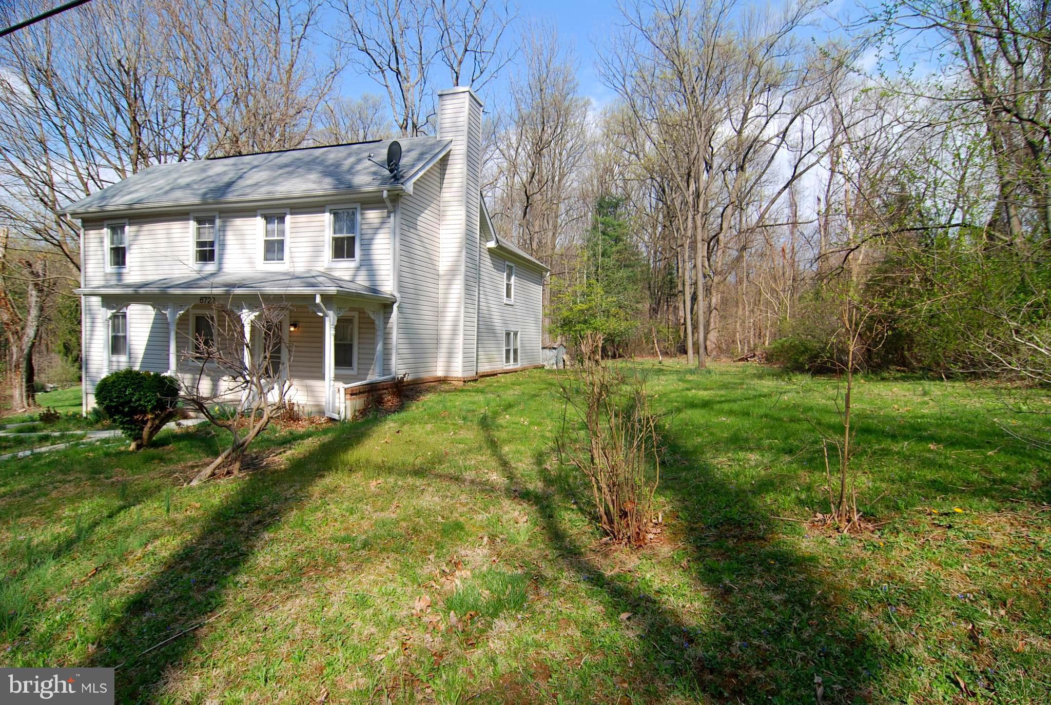 6722 South Clifton Road Frederick, MD 21703 - Photo 1 of 30 a view of a big yard with plants and large trees