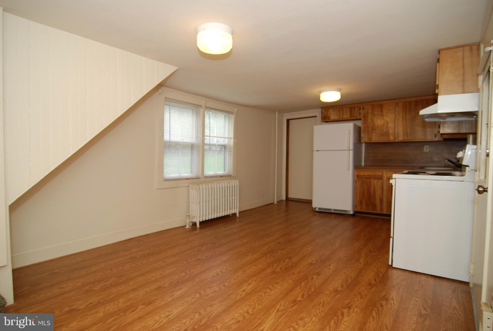 6722 South Clifton Road Frederick, MD 21703 - Photo 3 of 30 a view of a kitchen with a sink and a refrigerator