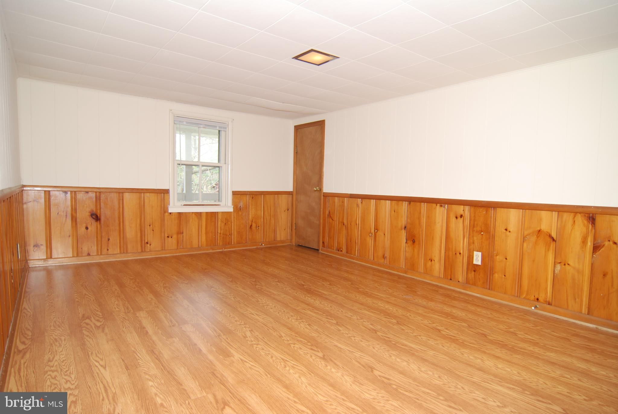 6722 South Clifton Road Frederick, MD 21703 - Photo 10 of 30 a view of an empty room with wooden floor and a window