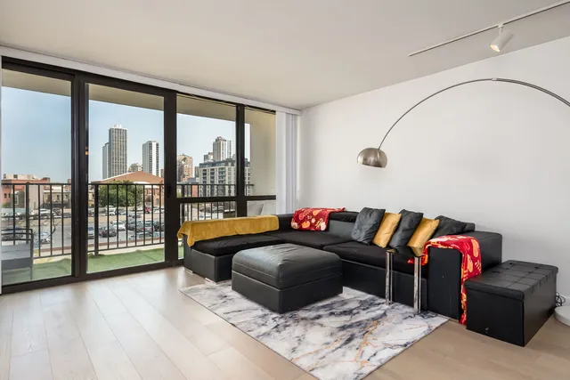 a living room with furniture and a floor to ceiling window