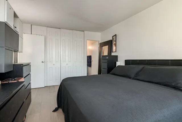 a bedroom with a bed and cabinets