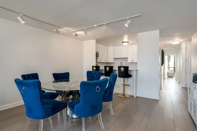 a dining room with furniture and wooden floor