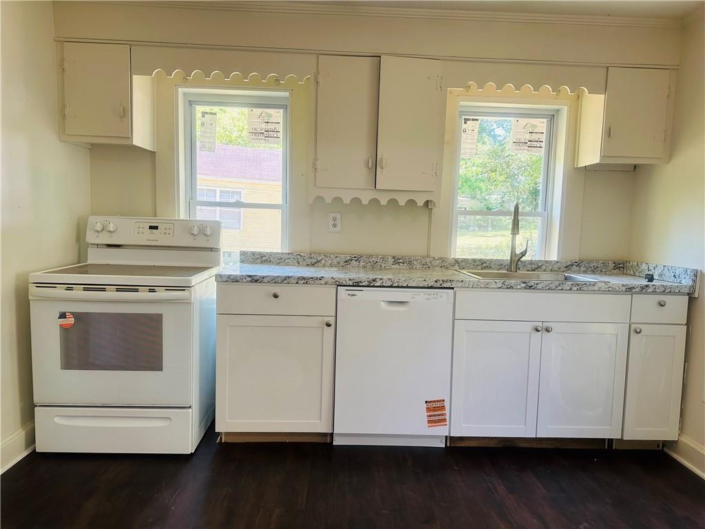 110 Bermuda Street Royston, GA 30662 - Photo 3 of 5 a kitchen with granite countertop white cabinets and a window