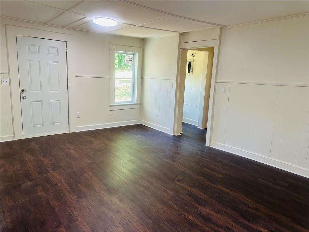 110 Bermuda Street Royston, GA 30662 - Photo 4 of 5 an empty room with wooden floor and windows