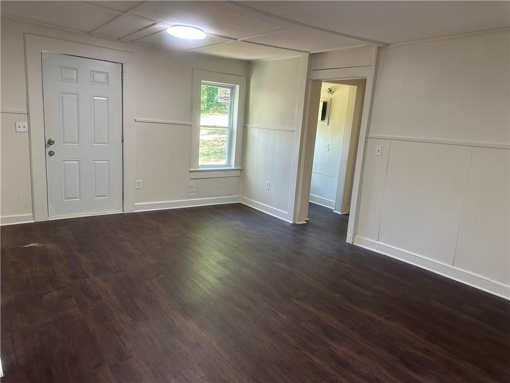 110 Bermuda Street Royston, GA 30662 - Photo 5 of 5 an empty room with wooden floor and windows