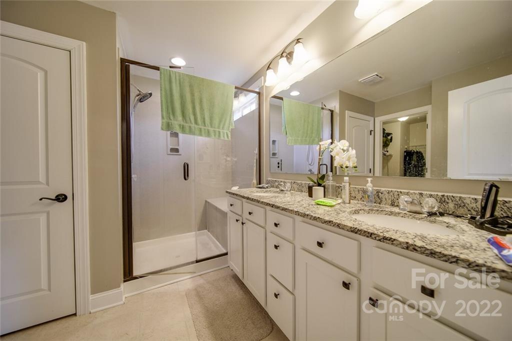 1684 Beleek Ridge Lane Clover, SC 29710 - Photo 12 of 20 a spacious bathroom with a granite countertop sink mirror and shower