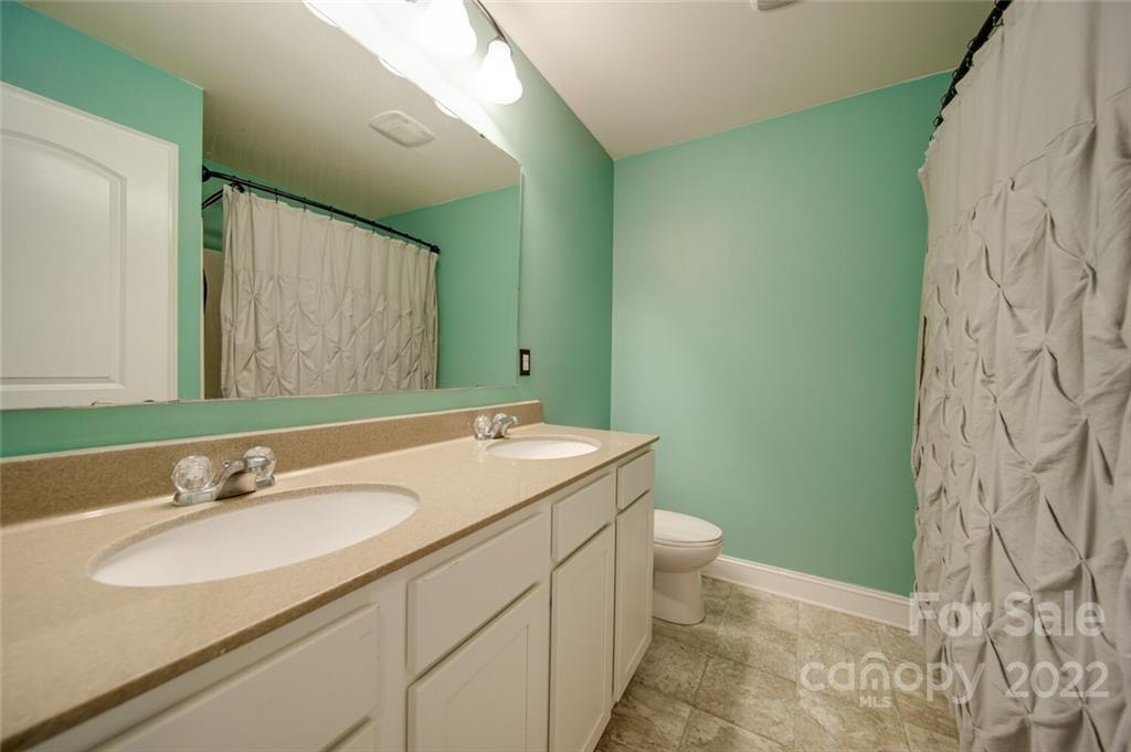 1684 Beleek Ridge Lane Clover, SC 29710 - Photo 18 of 20 a bathroom with a sink and mirror with toilet