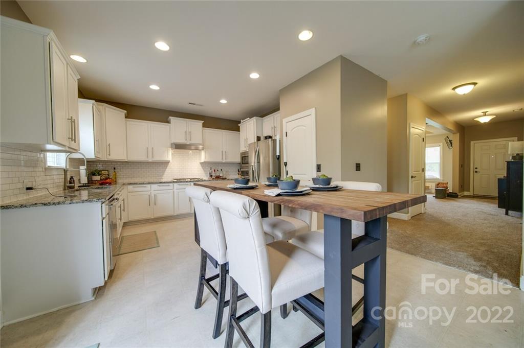 1684 Beleek Ridge Lane Clover, SC 29710 - Photo 5 of 20 a kitchen with granite countertop a table and chairs in it