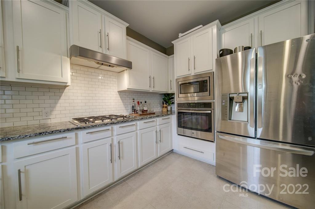 1684 Beleek Ridge Lane Clover, SC 29710 - Photo 6 of 20 a kitchen with granite countertop a refrigerator stove and cabinets