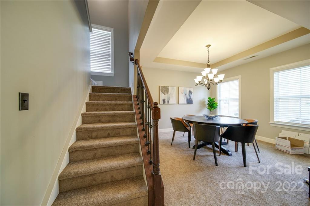 1684 Beleek Ridge Lane Clover, SC 29710 - Photo 8 of 20 a view of a dining room with furniture and a chandelier