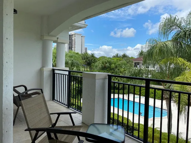a view of a chair and table in the balcony